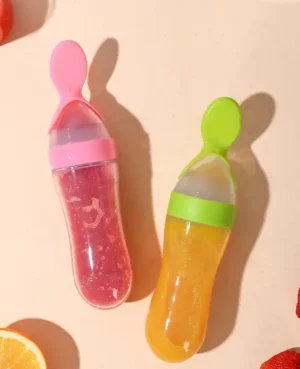 A variety of baby feeding bottles with spoons, in different colors and sizes